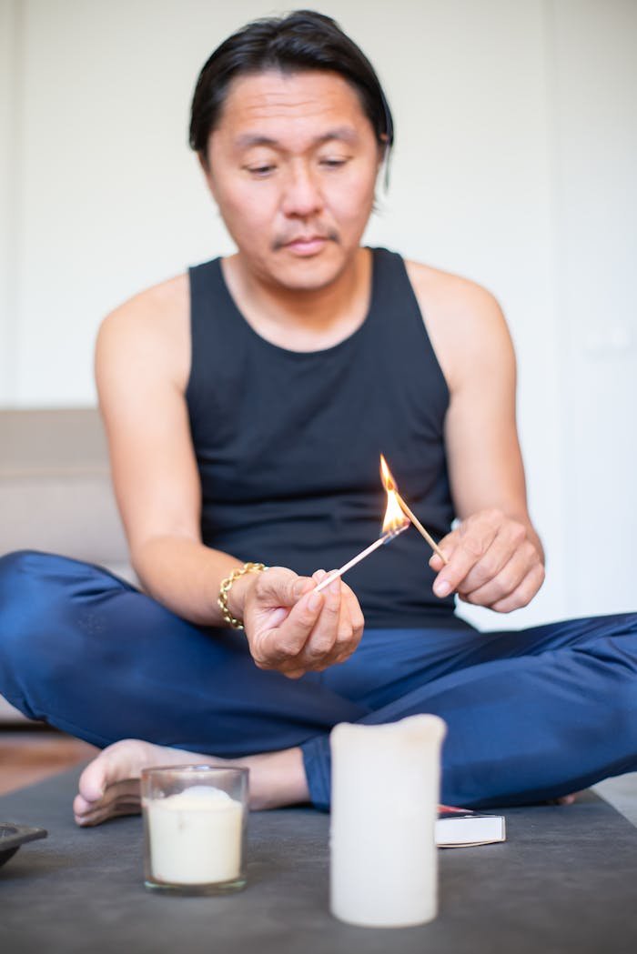 A Man in Tank Top Holding an Incense